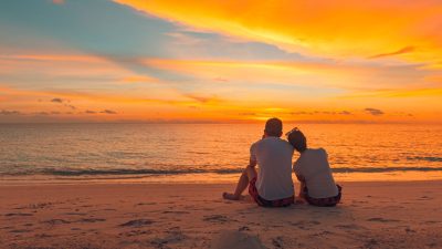 couple enjoying a peaceful sunset on the beach