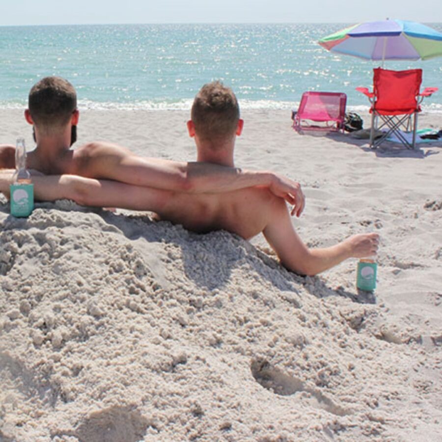 image of two men sitting in the sand
