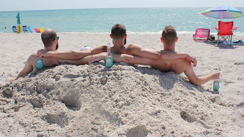 Guys hanging out on the beach